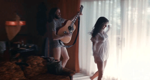 A Guy playing guitar Sexy girl dancing 