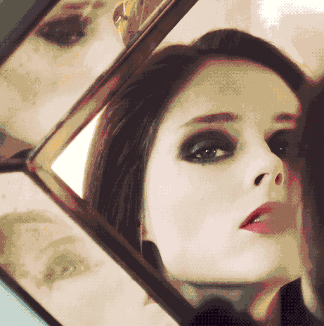 Ghotic girl looks at you in a mirror