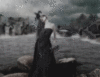 gothic woman by sea in rain